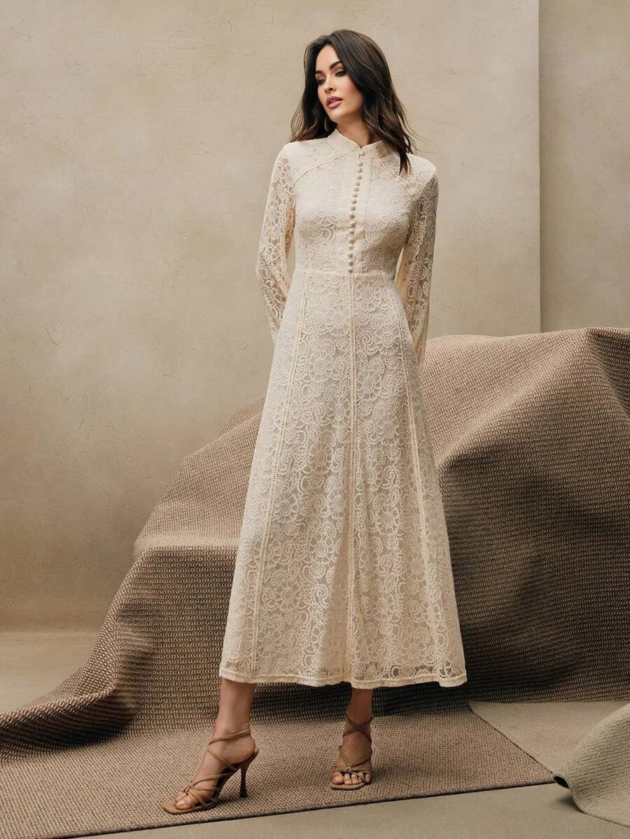 This elegant cream lace dress features a sophisticated high neckline and long sleeves, creating a timeless silhouette that's.