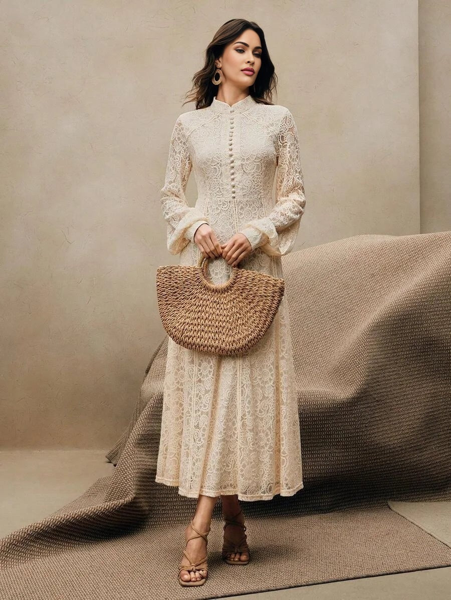 A delicate cream-colored lace dress features a high neckline and elegant, flowing sleeves, offering a flattering A-line.