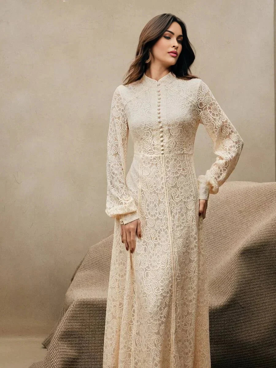 This elegant ivory lace dress features long sleeves and a high neckline, exuding a romantic charm. Its fitted bodice flows.