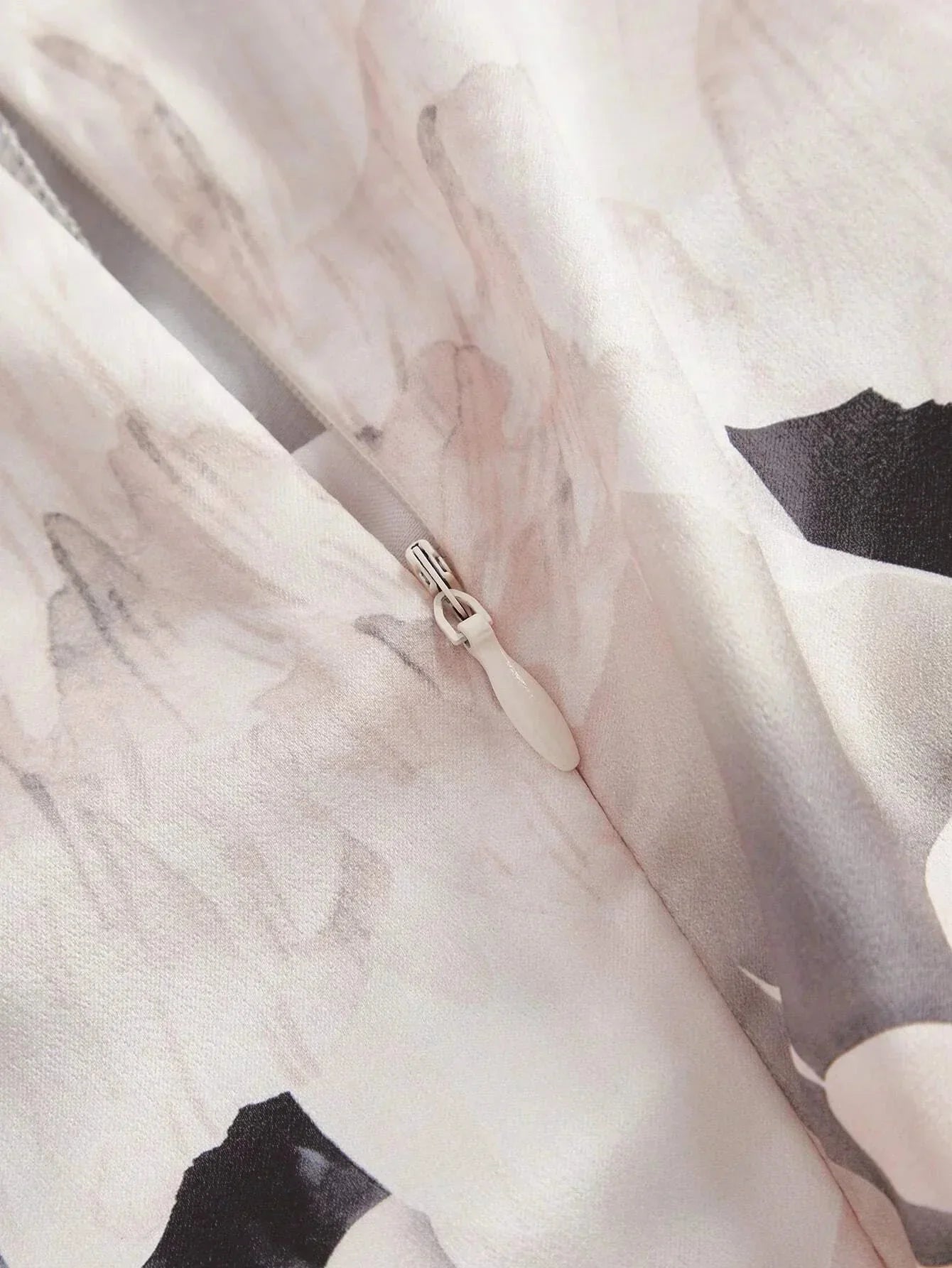 Delicate and airy, this sleeveless dress features a soft pink fabric adorned with a subtle floral print, perfect for a.