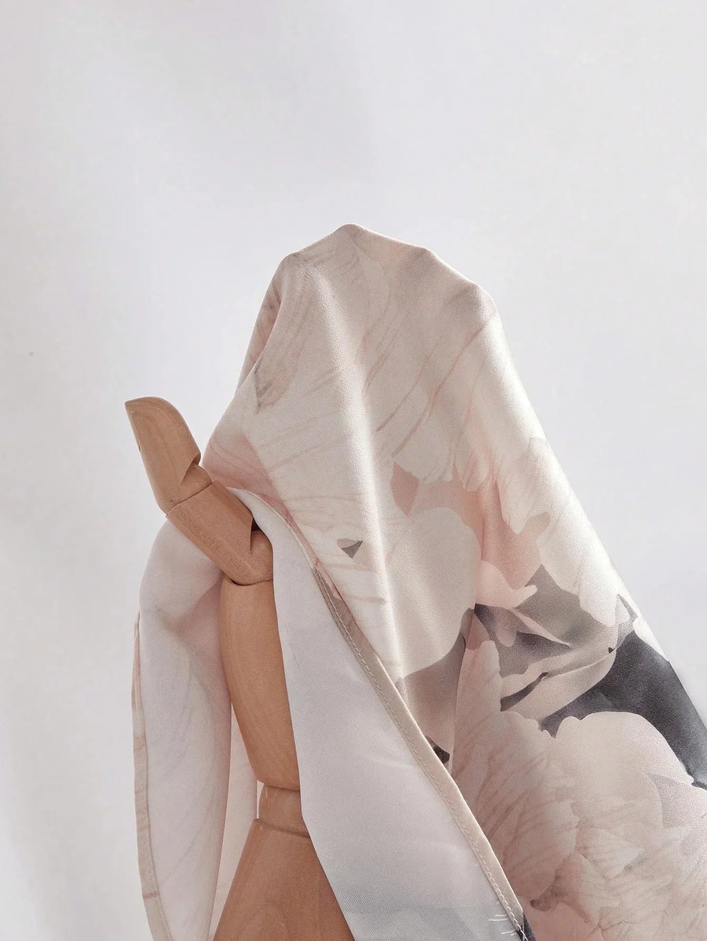 A delicate, flowing dress crafted from light, floral-printed fabric in soft pastels, featuring a relaxed fit that perfectly.