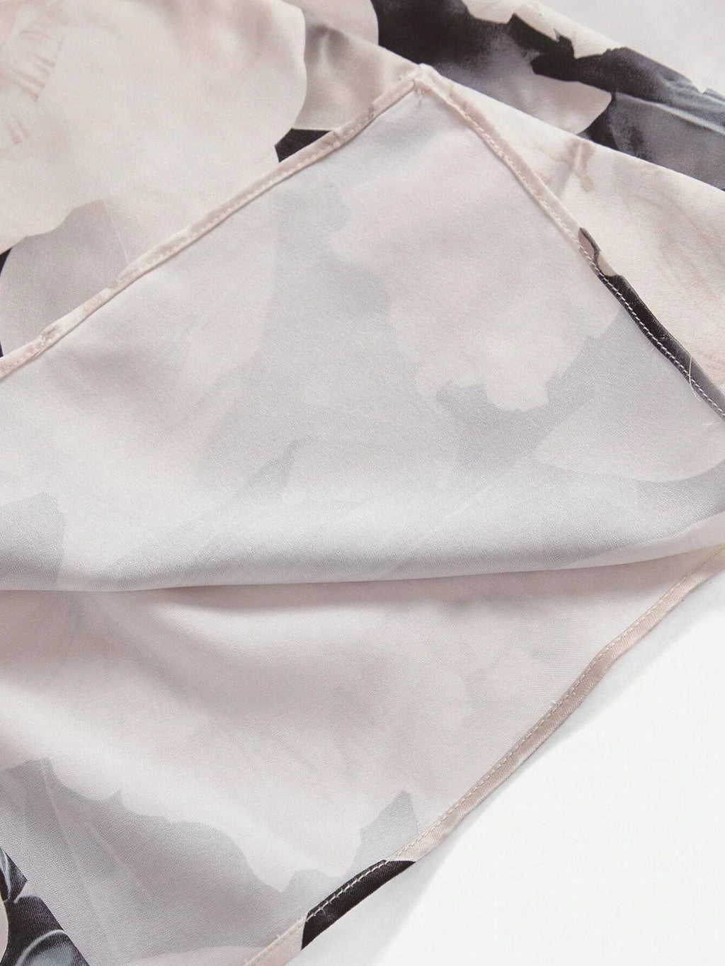 This elegant dress features a delicate blend of soft pastels adorned with a subtle floral pattern, expertly crafted from.