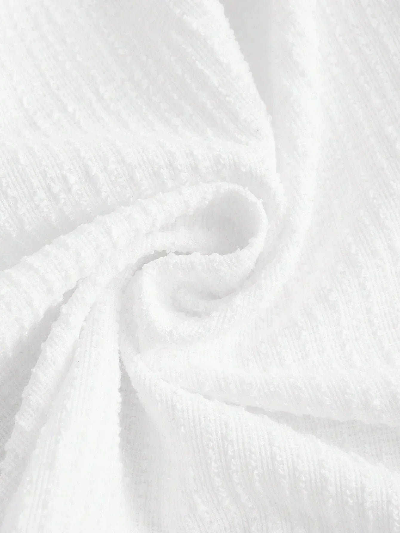 This elegant white dress features a soft, textured fabric that drapes beautifully for a flattering fit. Perfect for warm.