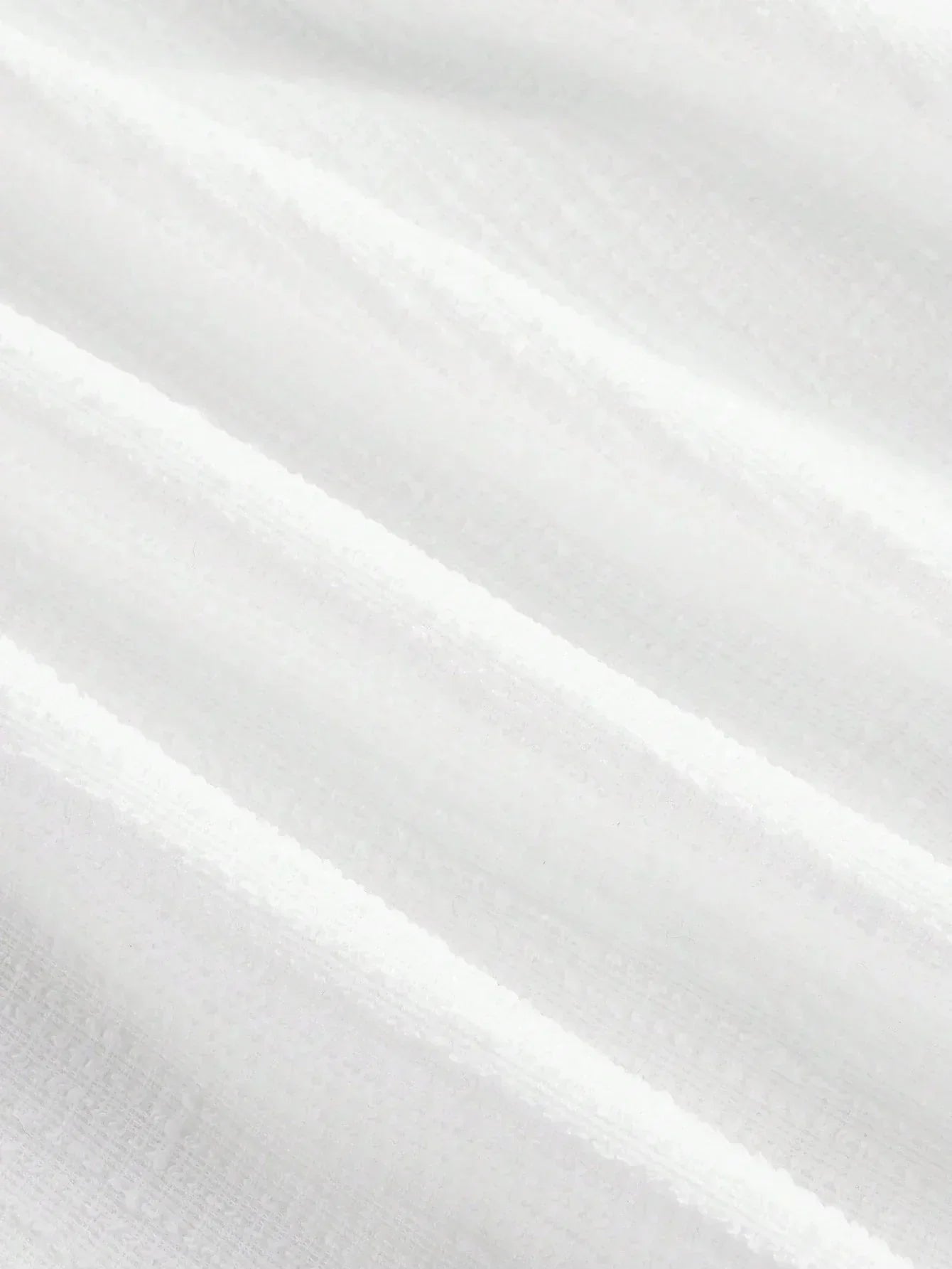 This elegant white dress features a flowing, lightweight fabric that drapes beautifully, enhancing its graceful silhouette..