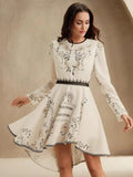 Embrace elegance with this cream long-sleeve dress adorned with delicate floral embroidery, highlighting a fitted bodice.