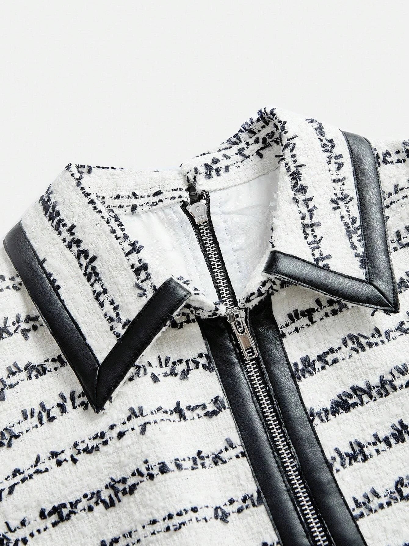 Elevate your style with this chic dress featuring a sophisticated blend of white and black hues, showcasing a textured.