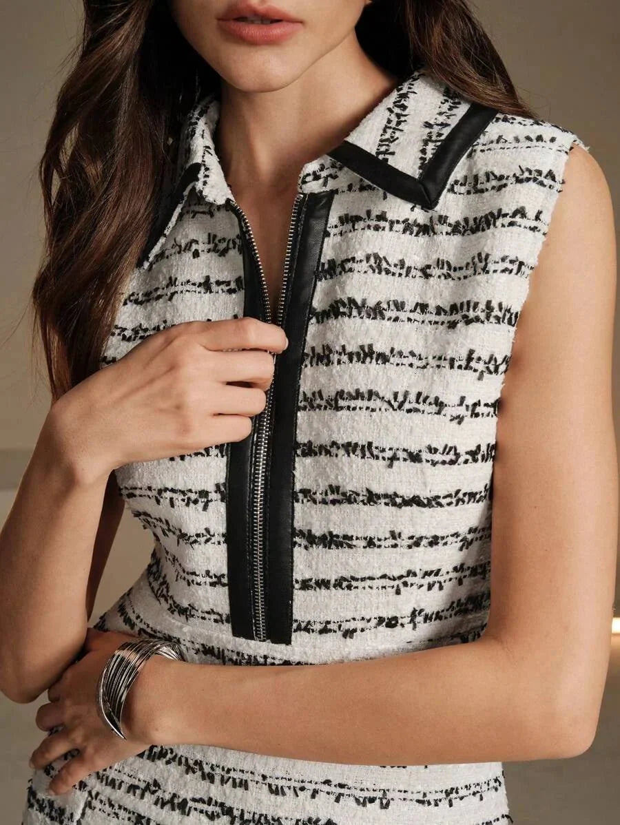 Stylish and sophisticated, this tailored sleeveless dress features a chic black and white striped pattern, complemented by a.