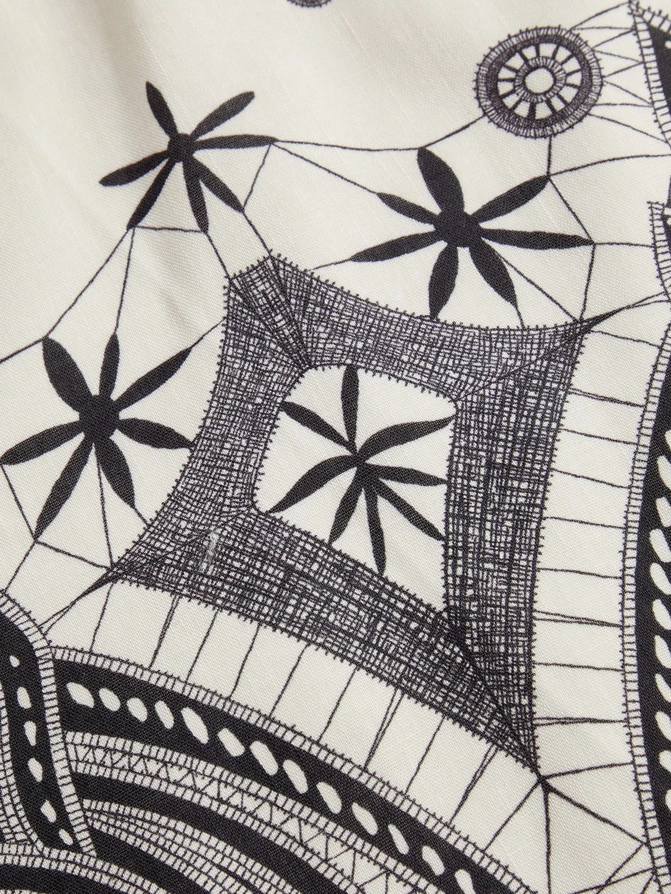 This stylish dress features a stunning black and white geometric pattern, crafted from a lightweight, breathable fabric that.