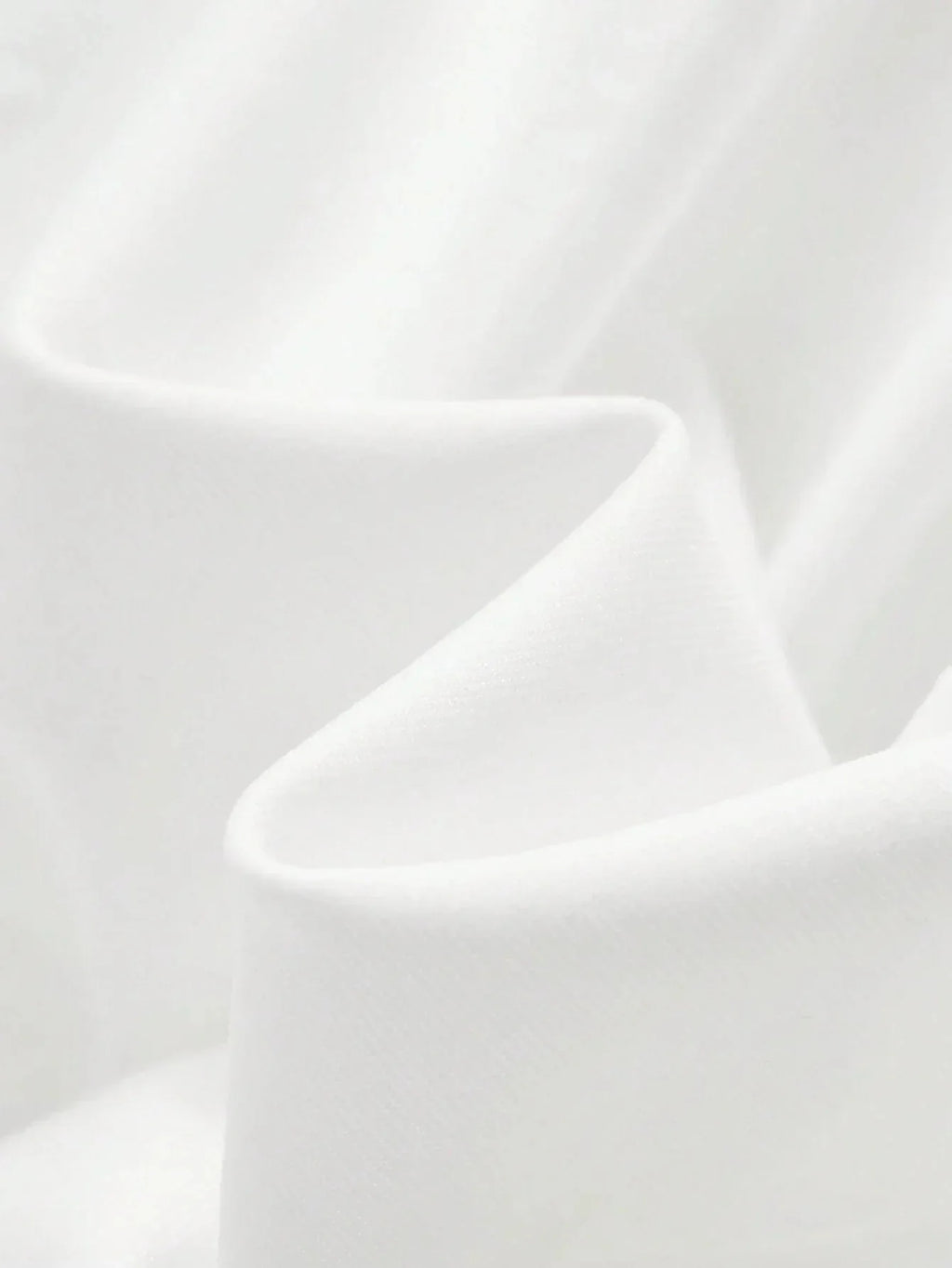 This stunning white dress features a soft, flowing fabric that drapes gracefully, creating an elegant and breathable fit.