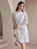 This elegant white dress features delicate floral embroidery and sheer long sleeves, creating a sophisticated and feminine.