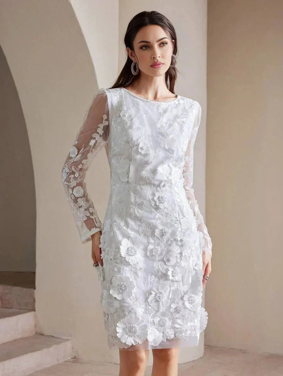 This elegant white dress features intricate floral embroidery and a chic silhouette with long sheer sleeves, ideal for.
