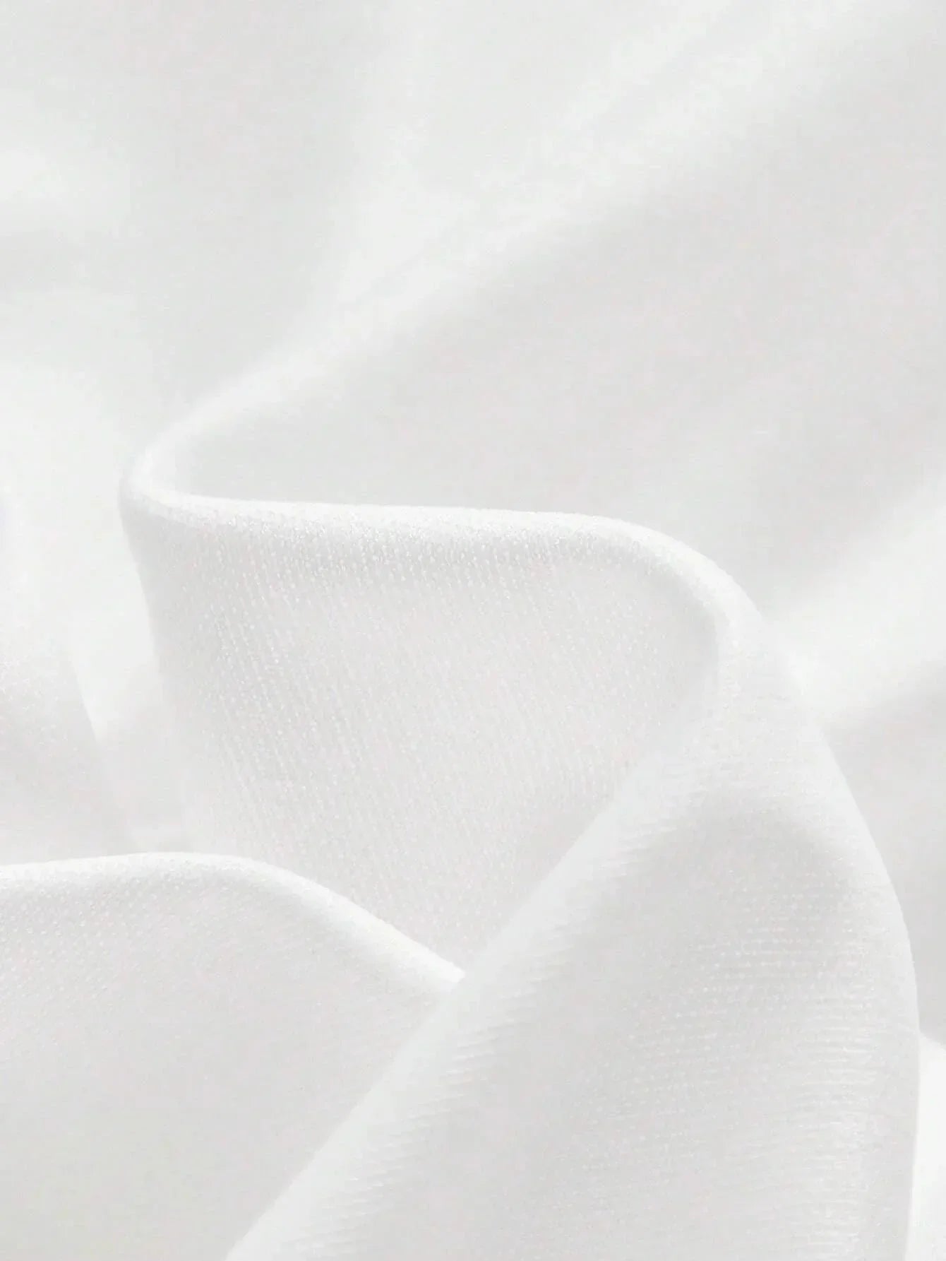 Luxurious and flowing, this elegant white dress is crafted from soft fabric that drapes beautifully, creating a flattering.