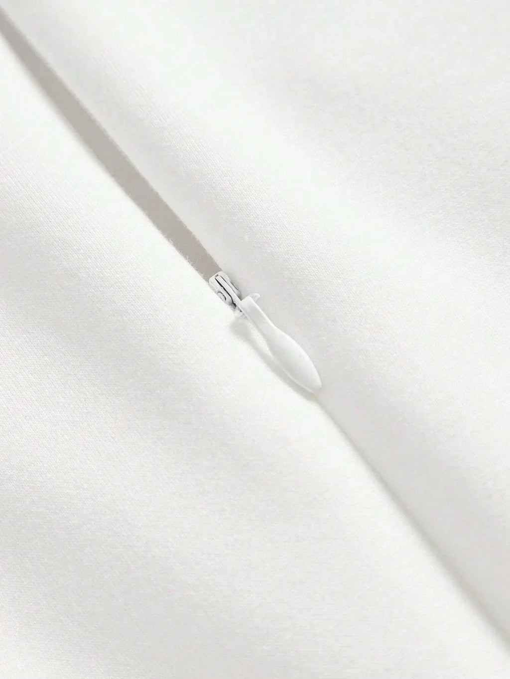This elegant white dress features a sleek, fitted design that exudes timeless sophistication, made from a soft, smooth.