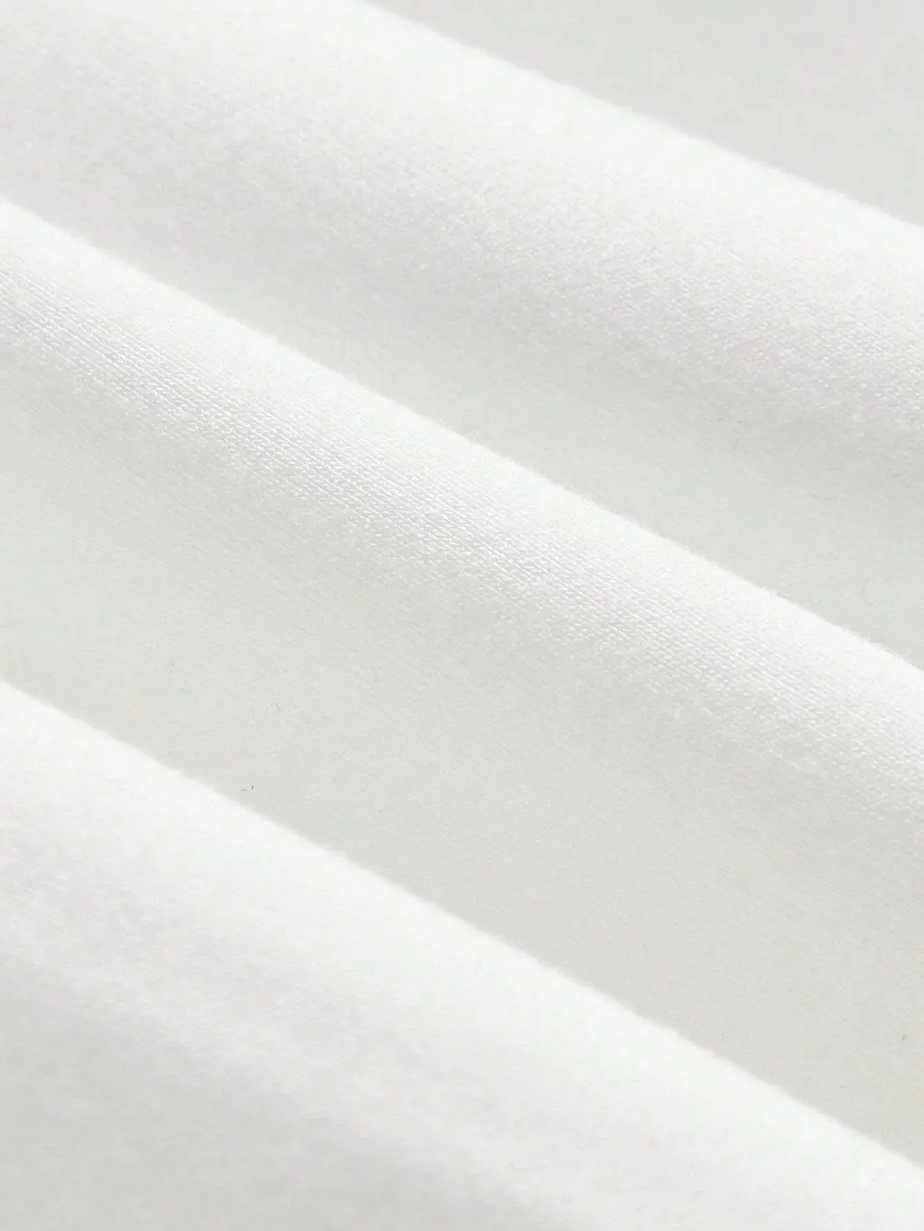 A soft, luxurious white dress crafted from a breathable cotton blend features a flattering fitted silhouette that gently.