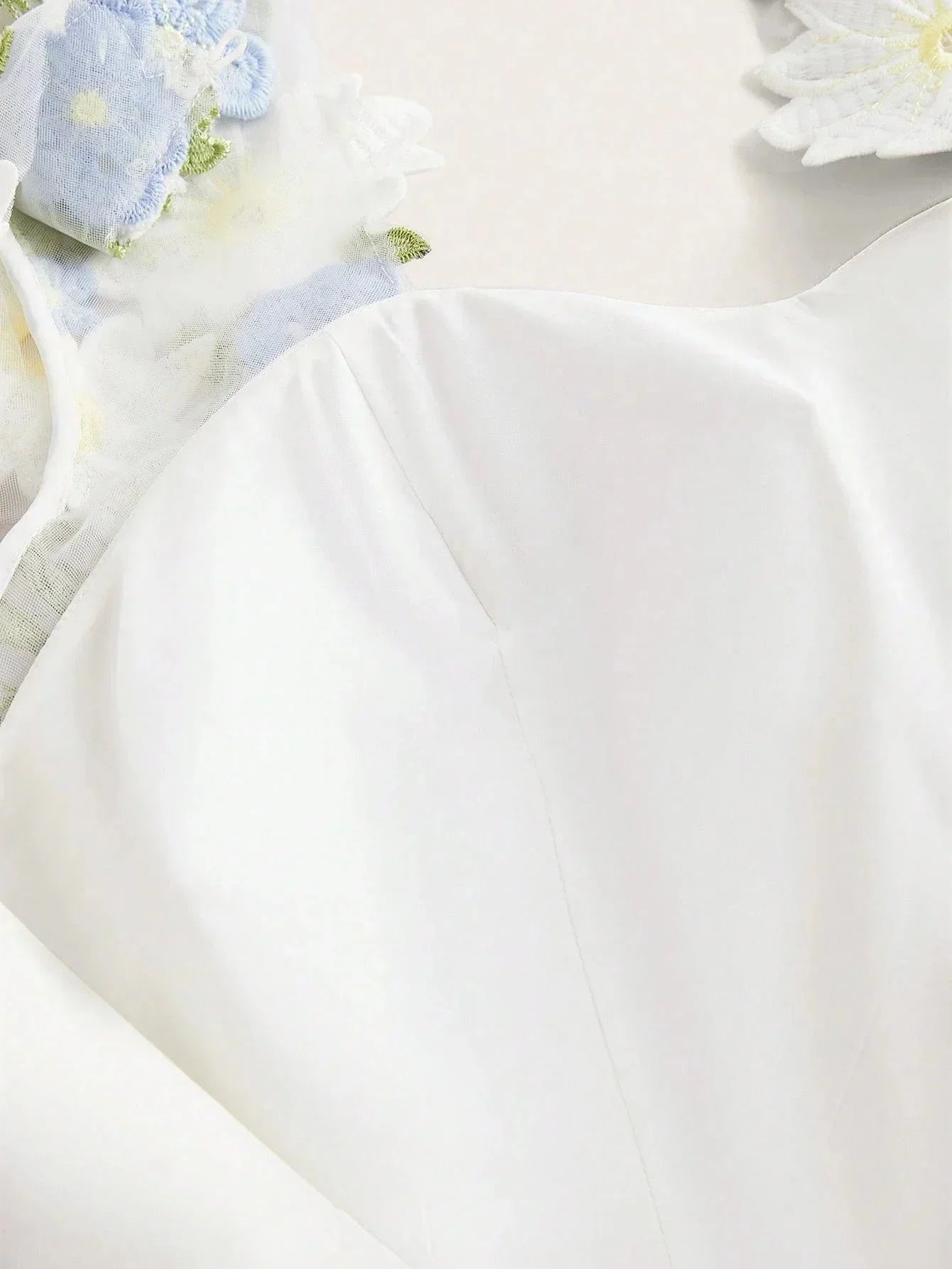 Float into elegance with this creamy white dress, featuring delicate floral embellishments and subtle sheer details that add.
