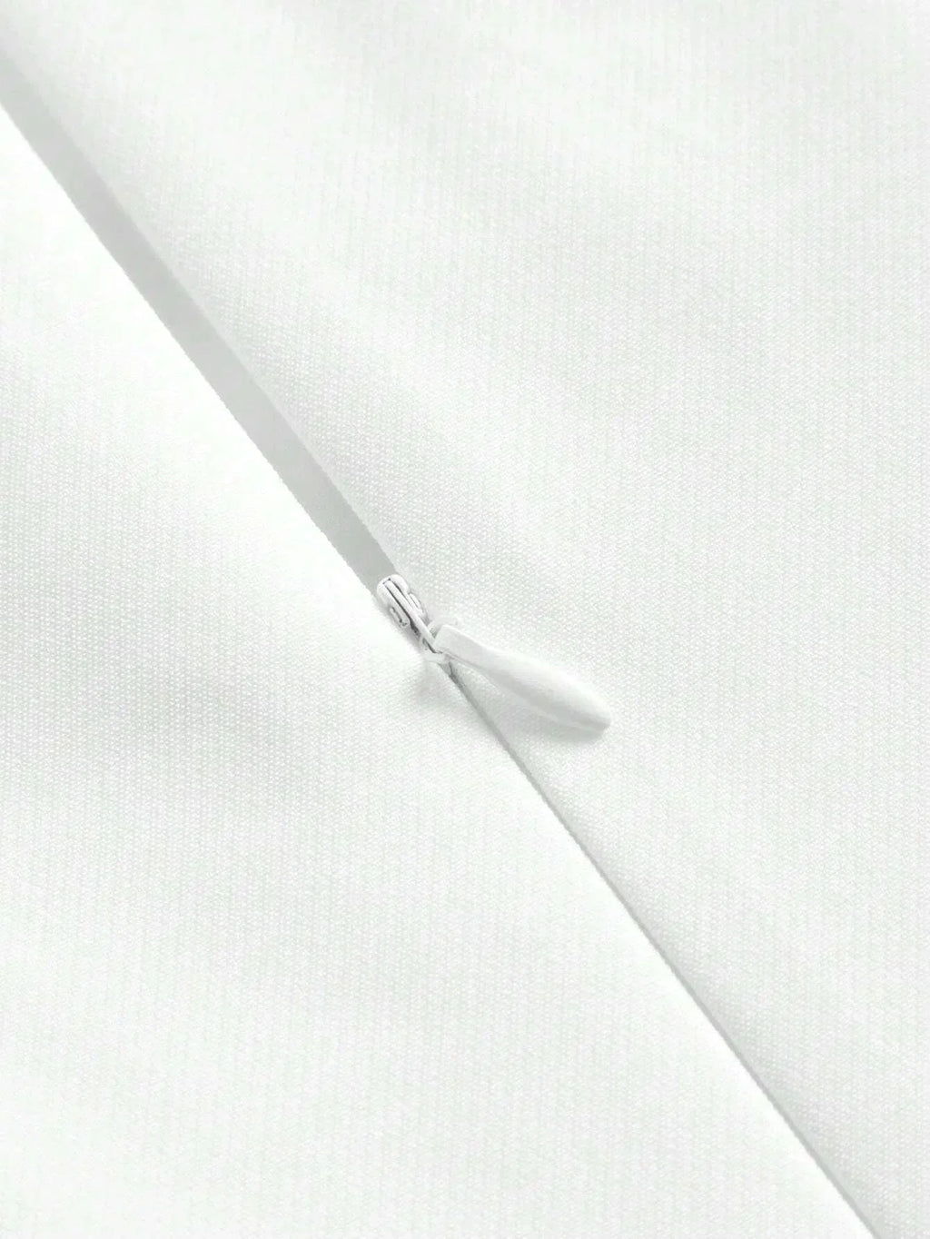 This elegant white dress features a sleek, fitted silhouette and a zipper closure for added convenience, showcasing a.
