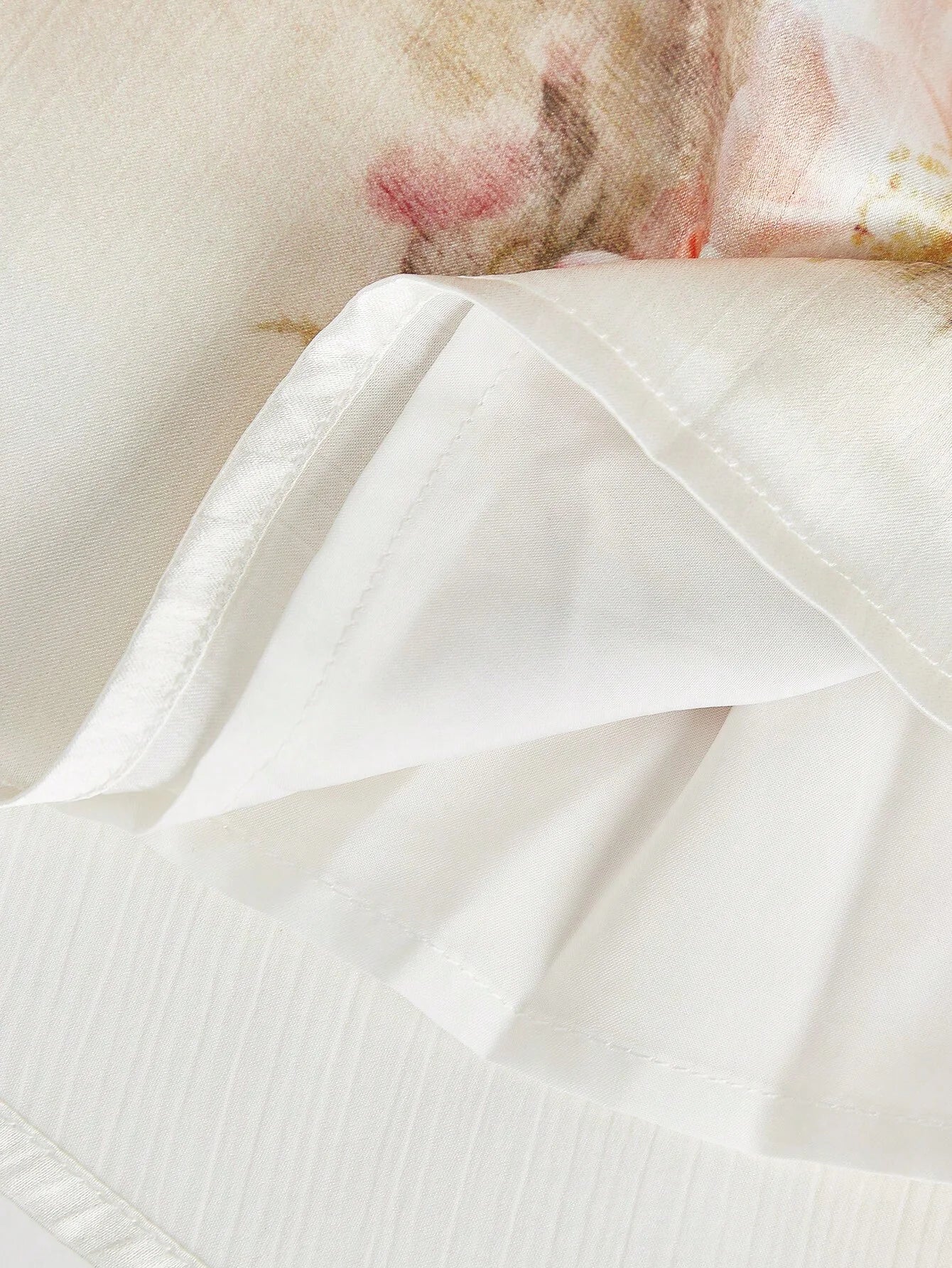 Delicate and flowy, this ivory dress features beautiful floral prints with soft pink accents, perfect for a romantic look..