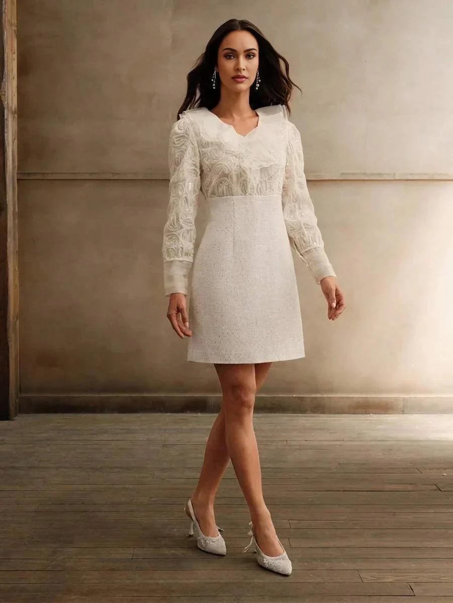 This elegant white dress features a flattering A-line silhouette and delicate floral embroidery on the long sleeves and.