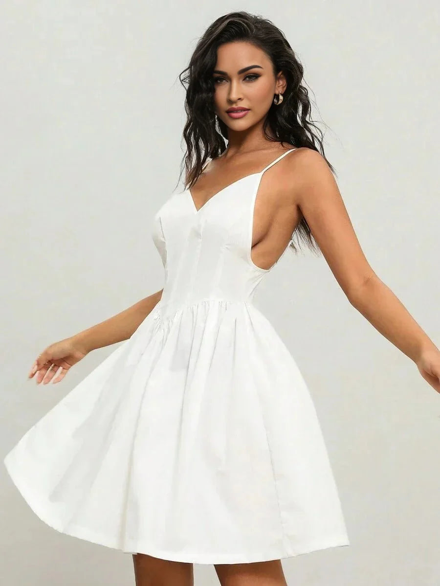 This charming white dress features a flirty A-line silhouette with delicate spaghetti straps and a flattering plunging.