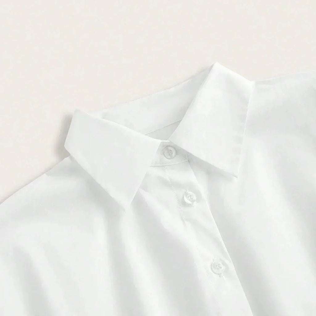 This crisp white dress shirt features a classic collar and button-down front, crafted from smooth, breathable cotton for a.
