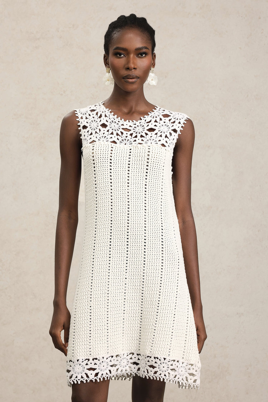 Luigia White Lace Sleeveless Mini Dress with Floral Patterns and Playful Hemline