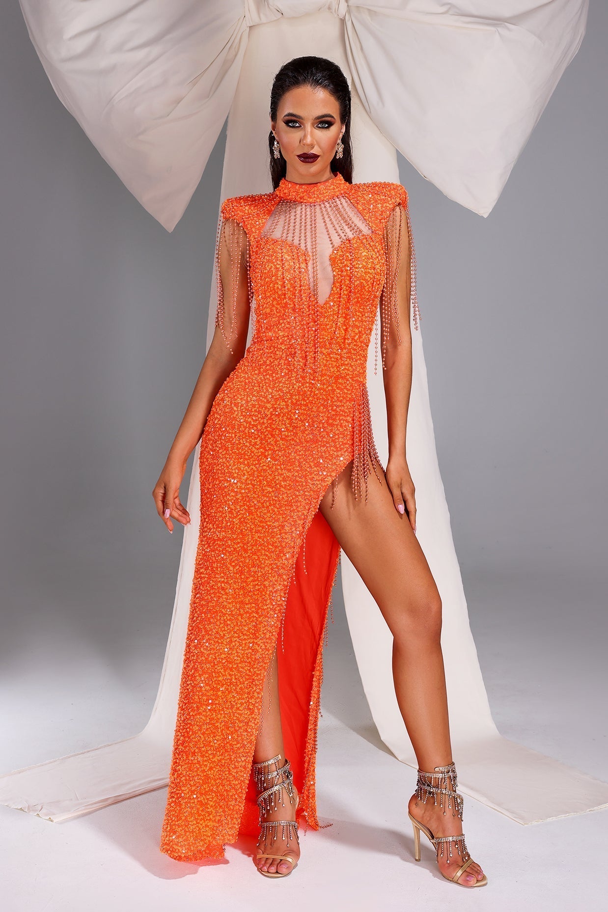 Mariangela Orange Sequin Maxi Dress with High Slit and Tassel Accents