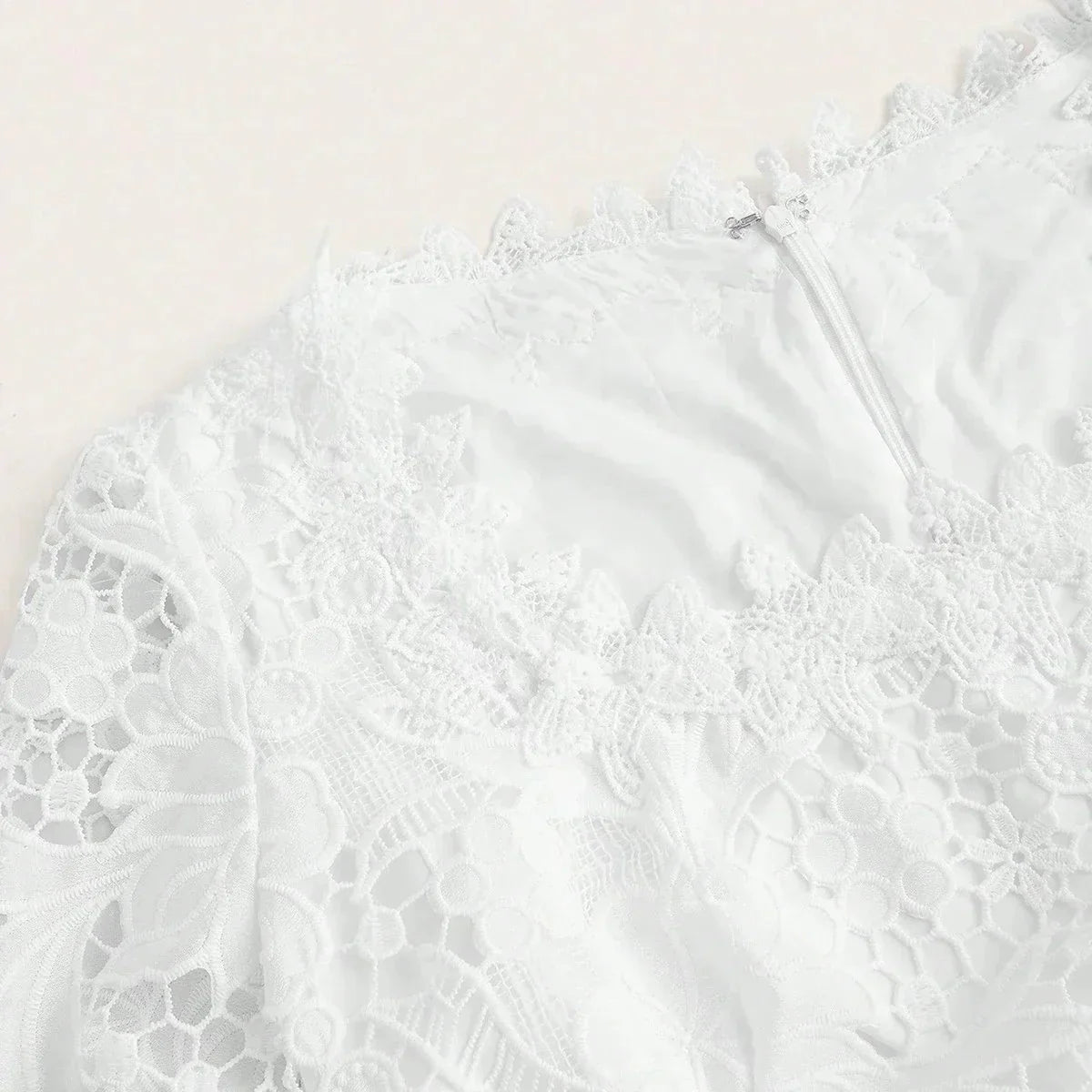 Delicate and ethereal, this white lace dress features intricate floral embroidery and a flattering fit that enhances the.