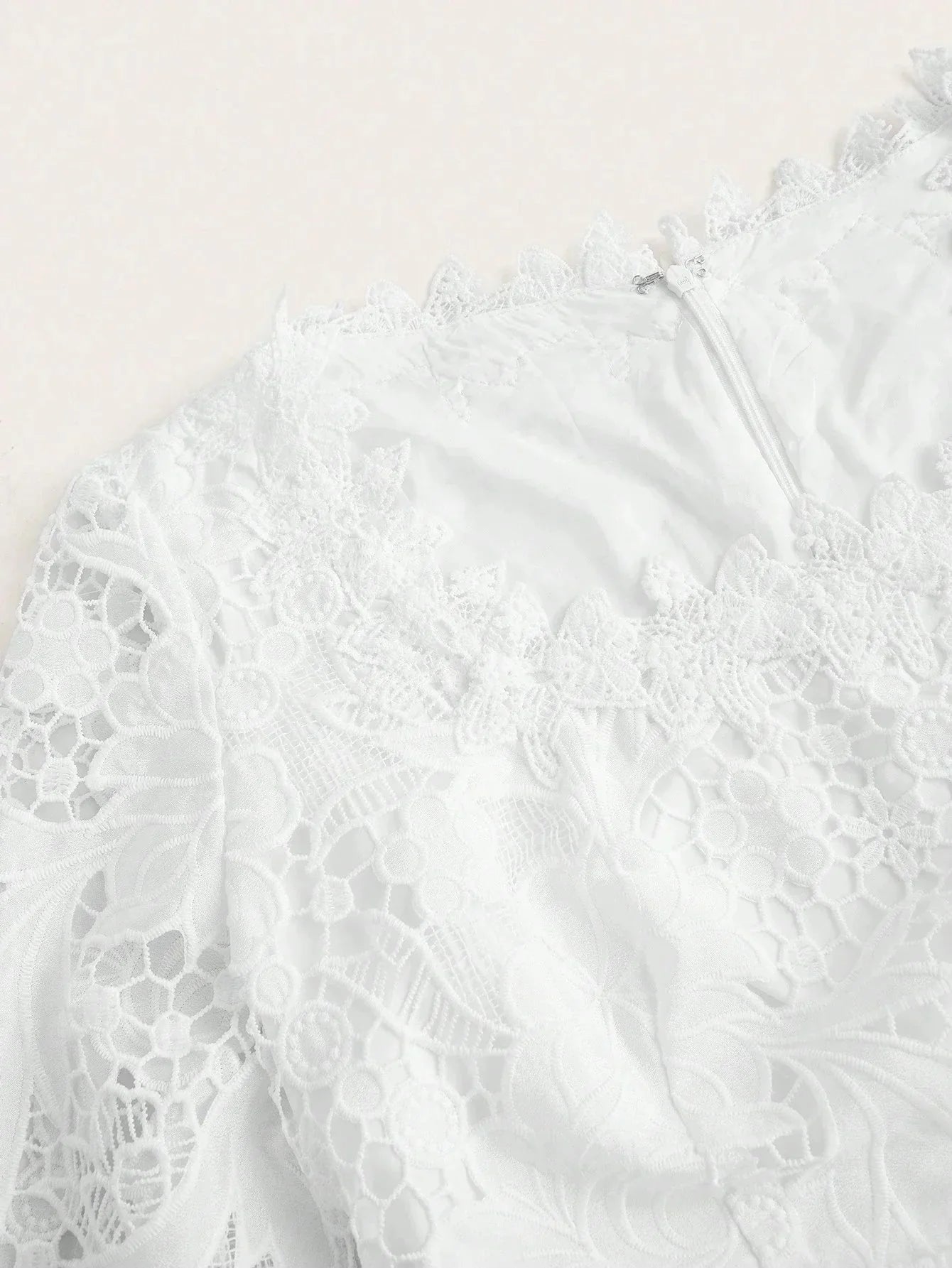Elevate your wardrobe with this elegant white lace dress featuring intricate floral patterns and a delicate scalloped.
