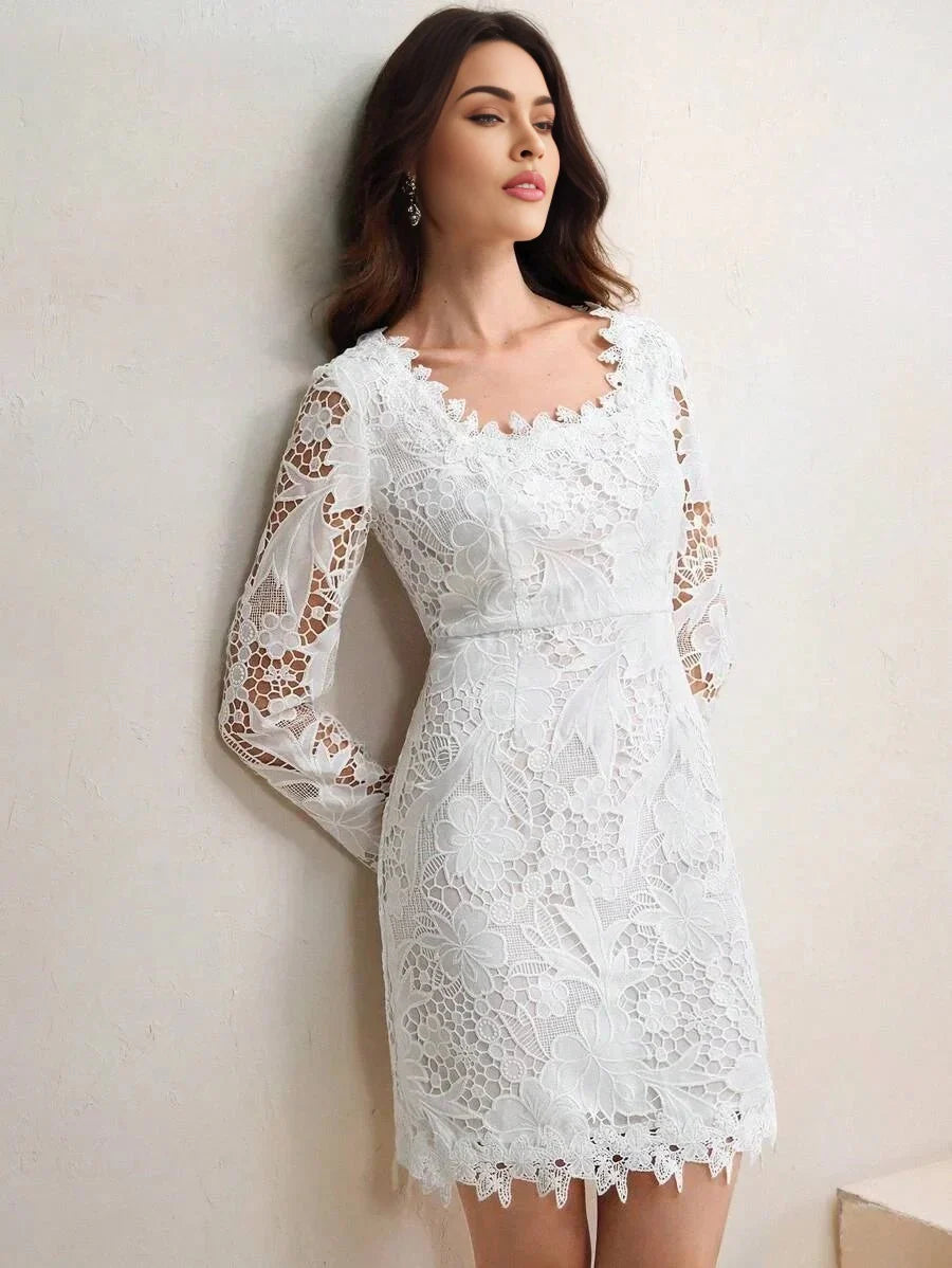 This elegant white dress features a stunning floral lace design with long, sheer sleeves and a flattering fitted silhouette..