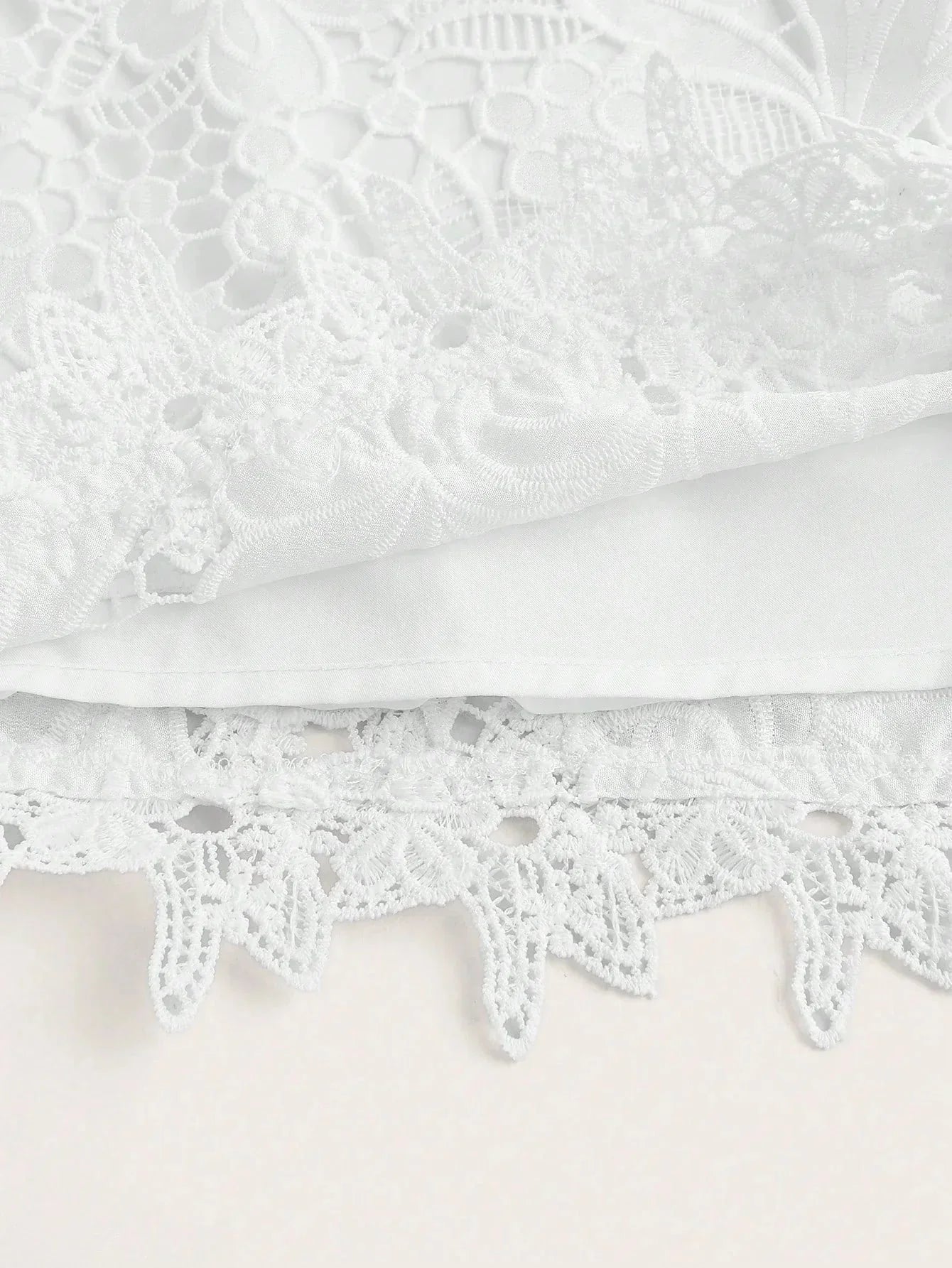 Delicate and enchanting, this white lace dress features intricate floral patterns and a soft, flowing silhouette. Crafted.
