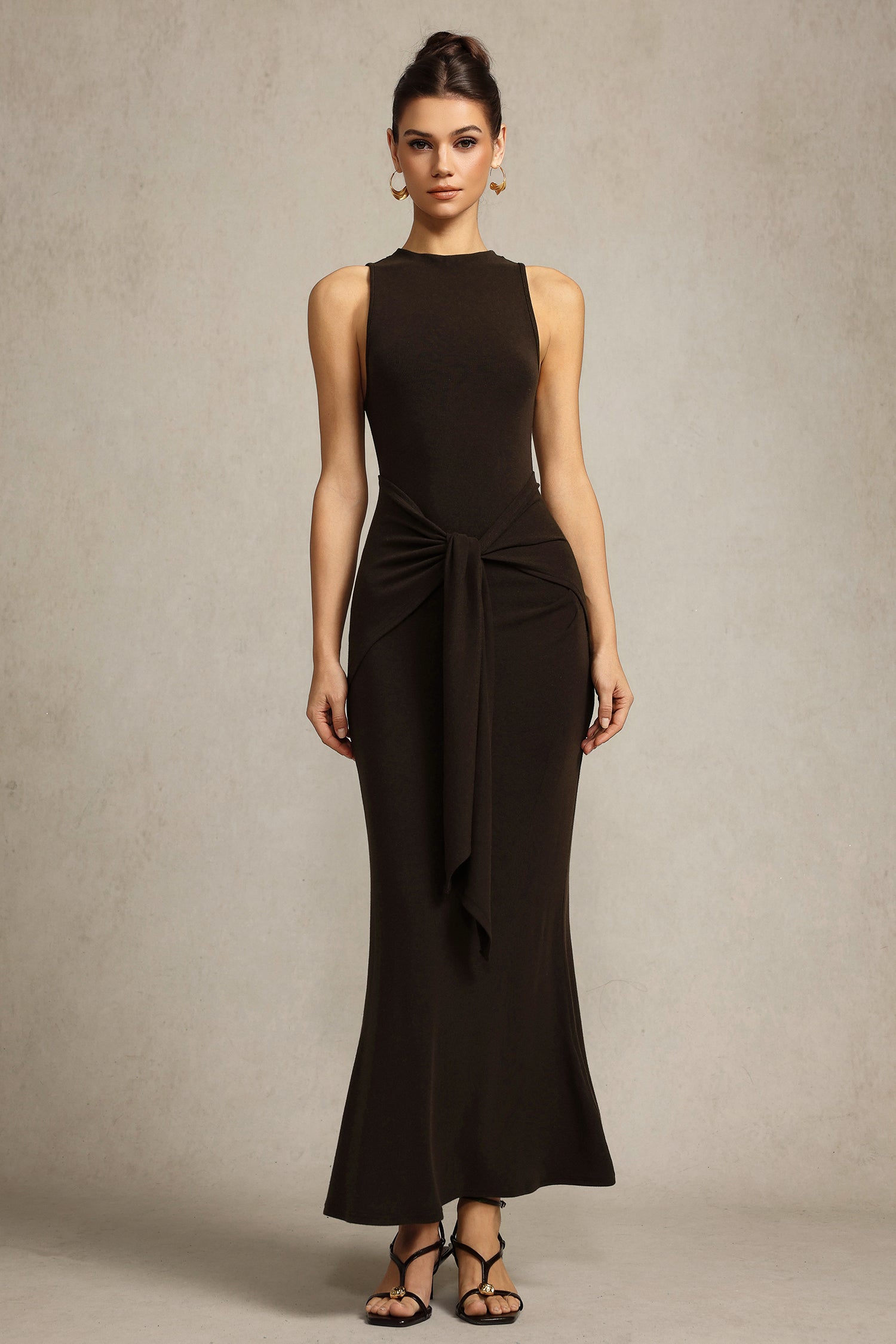Melissa brown elegant sophisticated sleeveless dress with unique folds at waist and high neckline for formal events or gatherings