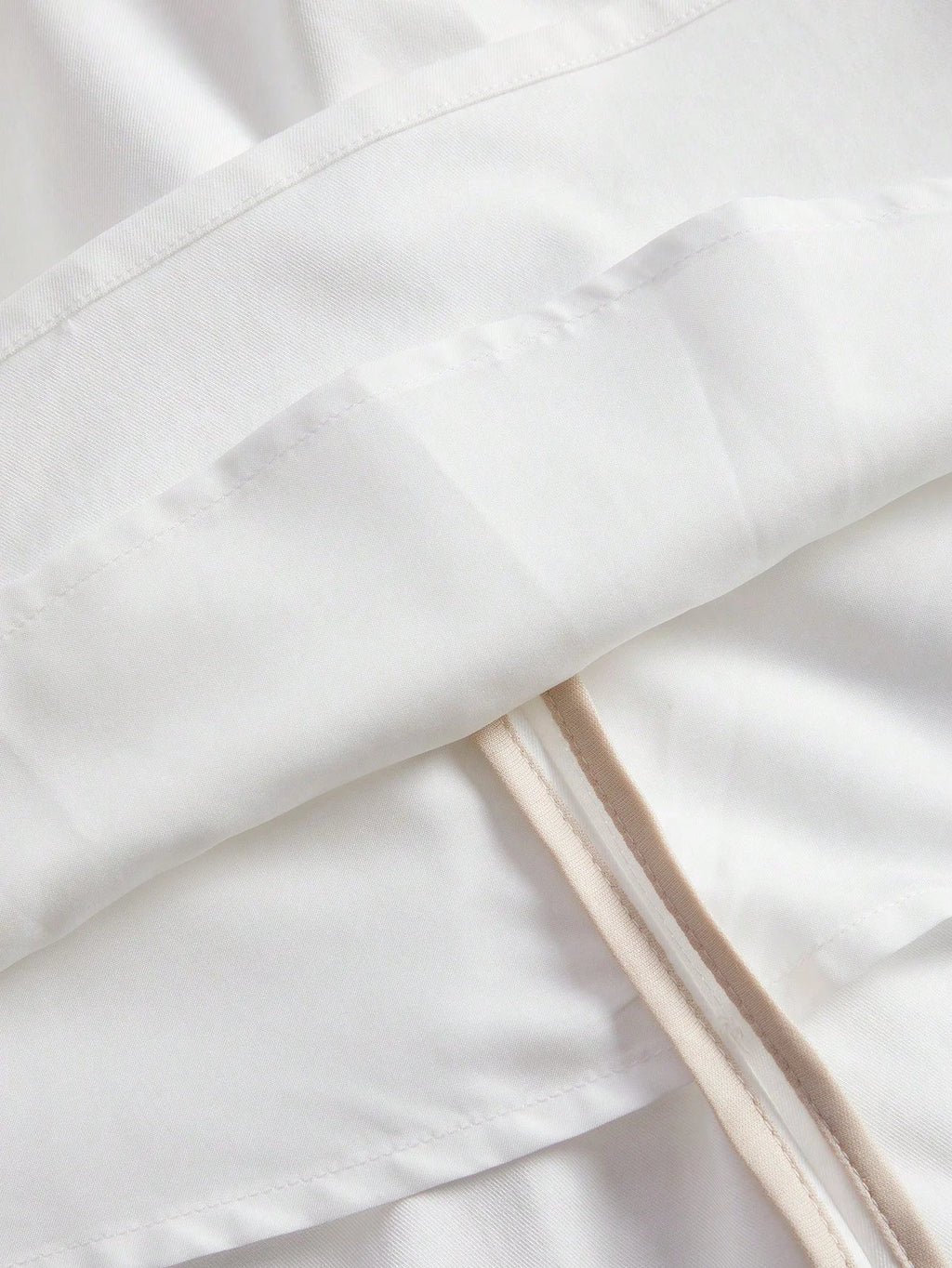 Embrace elegance with this flowing white dress, featuring delicate fabric panels that create a soft, romantic silhouette..