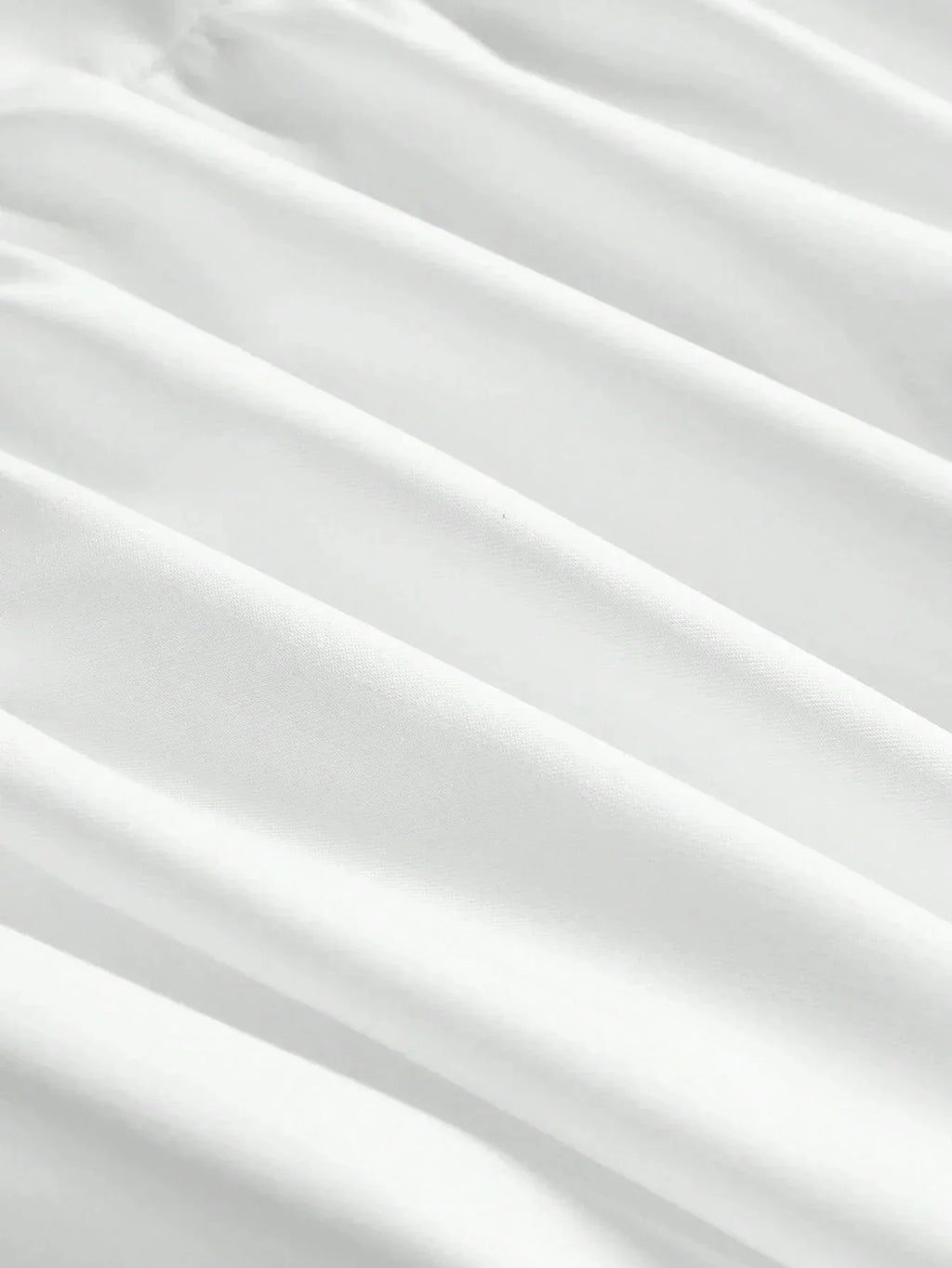 This elegant white dress features a flowing silhouette with soft, delicate pleats that enhance its graceful design. Made.