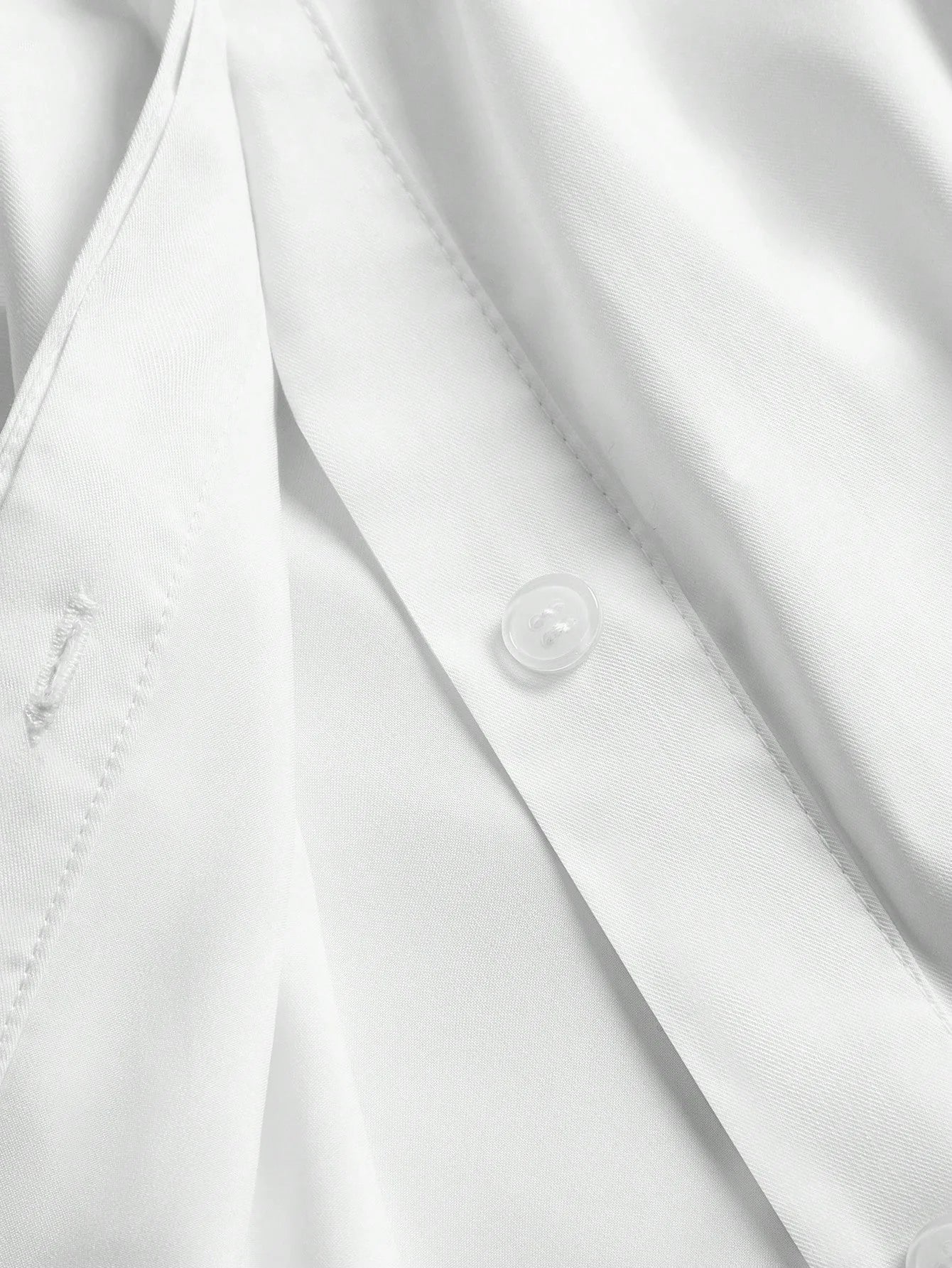 This elegant white dress features a sleek button-up design, showcasing a refined and polished look perfect for various.