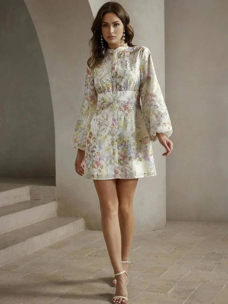 This elegant mini dress features a soft, pastel floral print that exudes femininity, with billowy long sleeves and a.