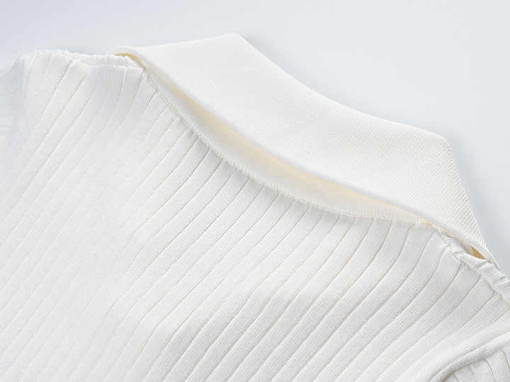 Raven Top – Fitted Ribbed Knit – Collared Design – Gold Button Accents – Decorative Pockets – Tailored Silhouette – Stretch Fabric