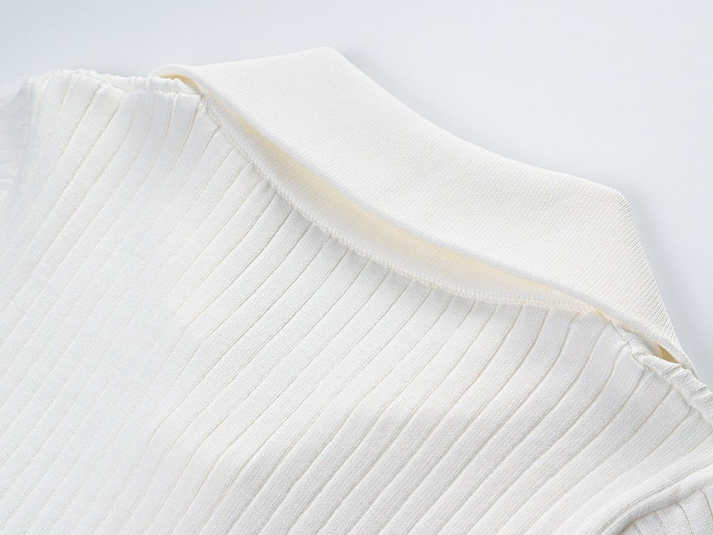 Raven Top – Fitted Ribbed Knit – Collared Design – Gold Button Accents – Decorative Pockets – Tailored Silhouette – Stretch Fabric