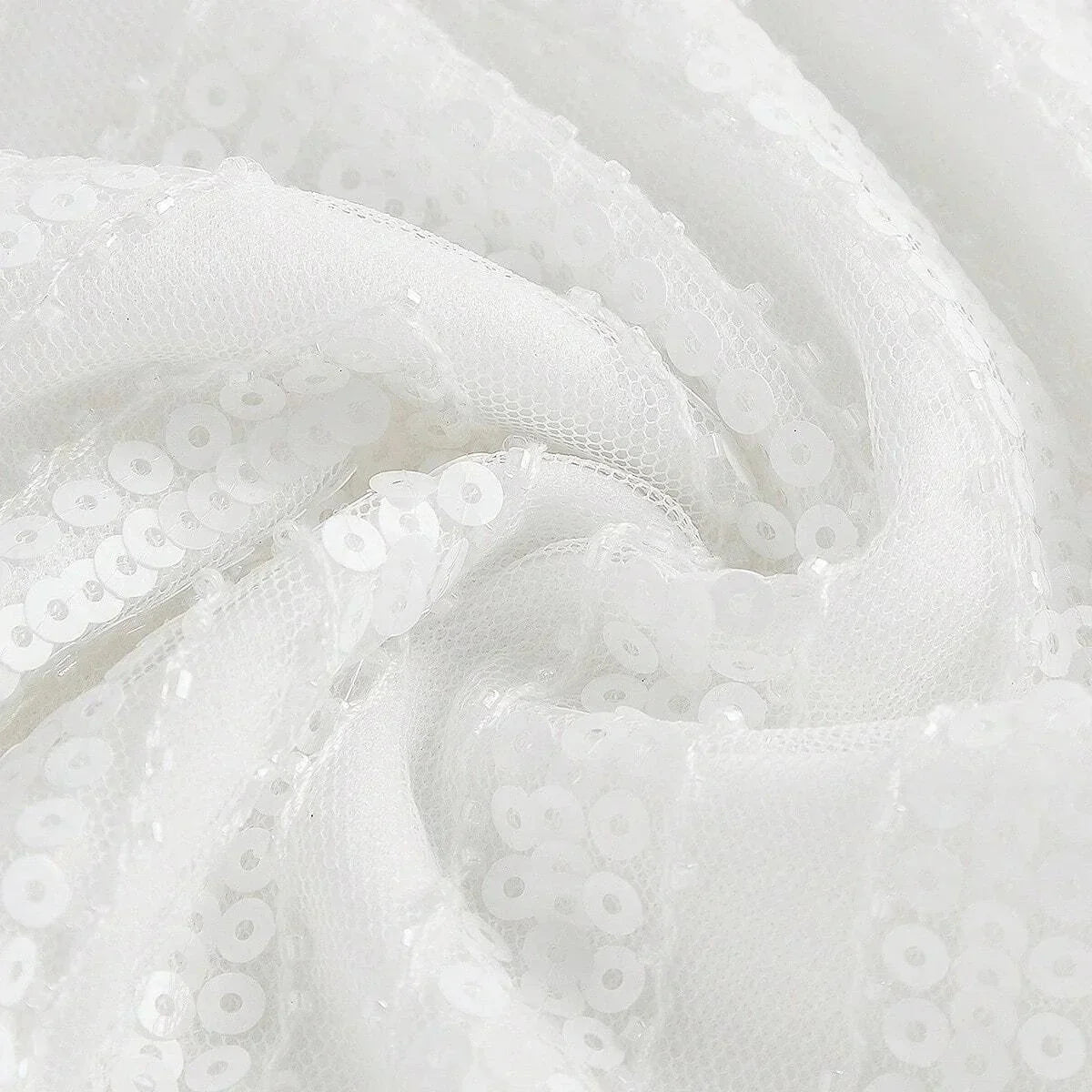 This elegant white dress showcases a shimmering sequined fabric that catches the light beautifully, creating a stunning.