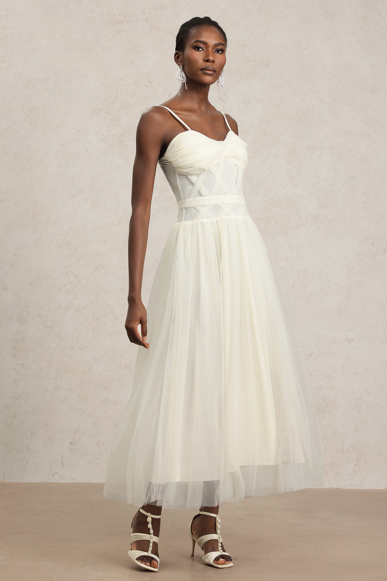 Valerie White Halterneck Formal Dress with Intricate Detailing and Flowing Skirt